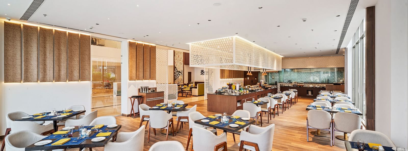 A dining setting at Grand Vijayawada Restaurant at Grand Vijayawada by GRT Hotels.