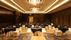  A hall with chairs and tables arranged for an event at Pride Plaza, New Delhi.