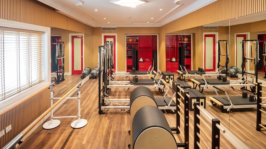 An image of workout equipment at Sumaya at The Claridges New Delhi with sunlight coming from the window into the gym