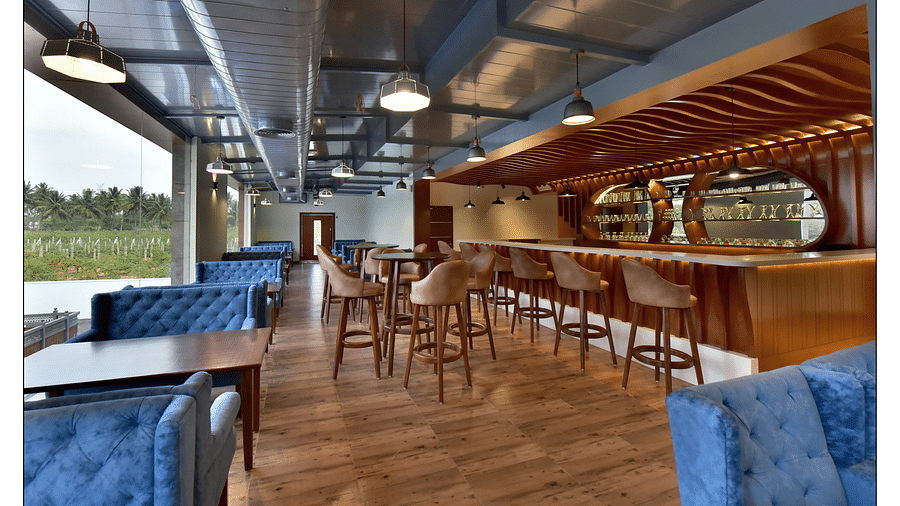 panoramic view of lotus bar along with a dining area in the corner placed next to floor-to-ceiling window - Royal Lotus View Resotel1