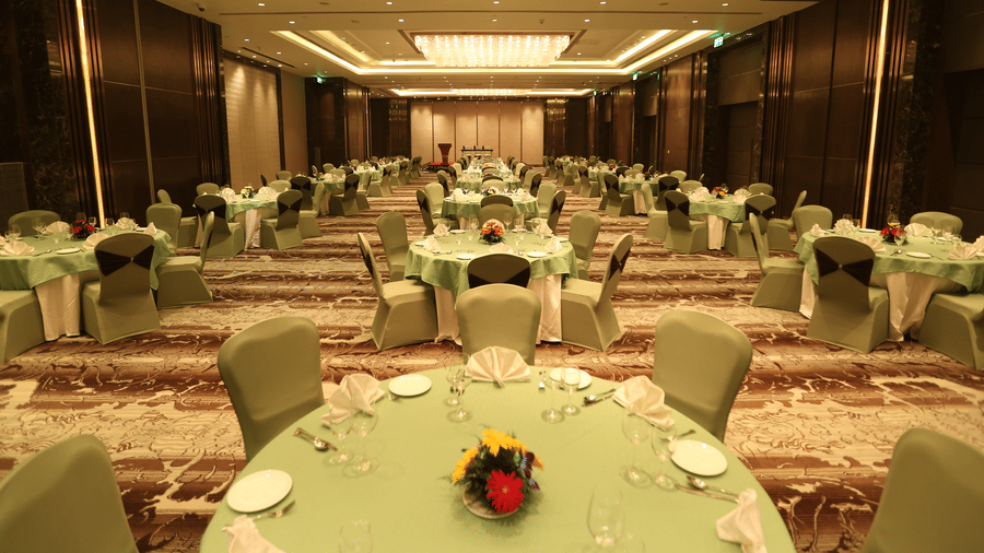 A Banquet Hall at Pride Plaza Hotel, New Delhi, with several chairs and tables set up for an event.