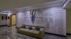 an antelope head showpiece above a three seater sofa in front of the entrance of Grand Continent, Mahabalipuram