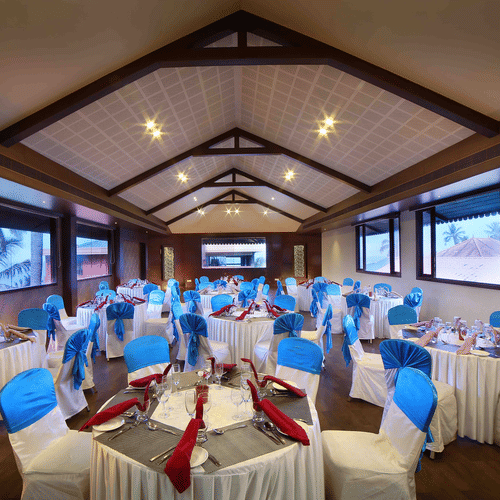 An elegant banquet hall with ambient lighting, ample seating, and refined interior at Uday Samudra Leisure Beach Hotel