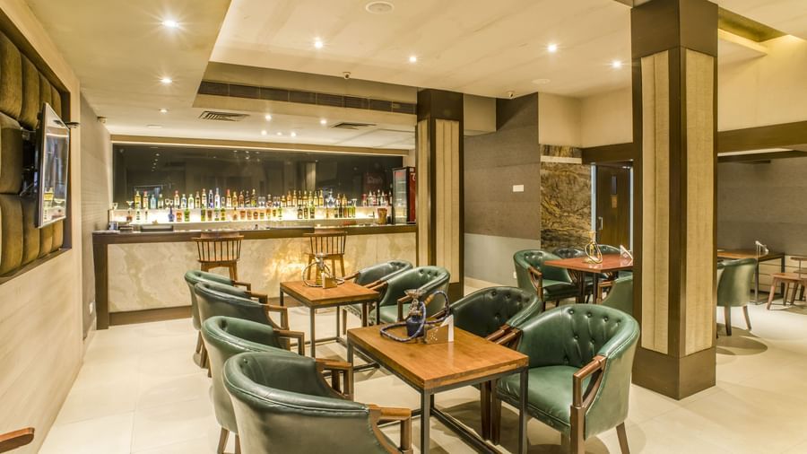 A bar area with tables and chairs at The Citi Residence Hotel, Asansol.