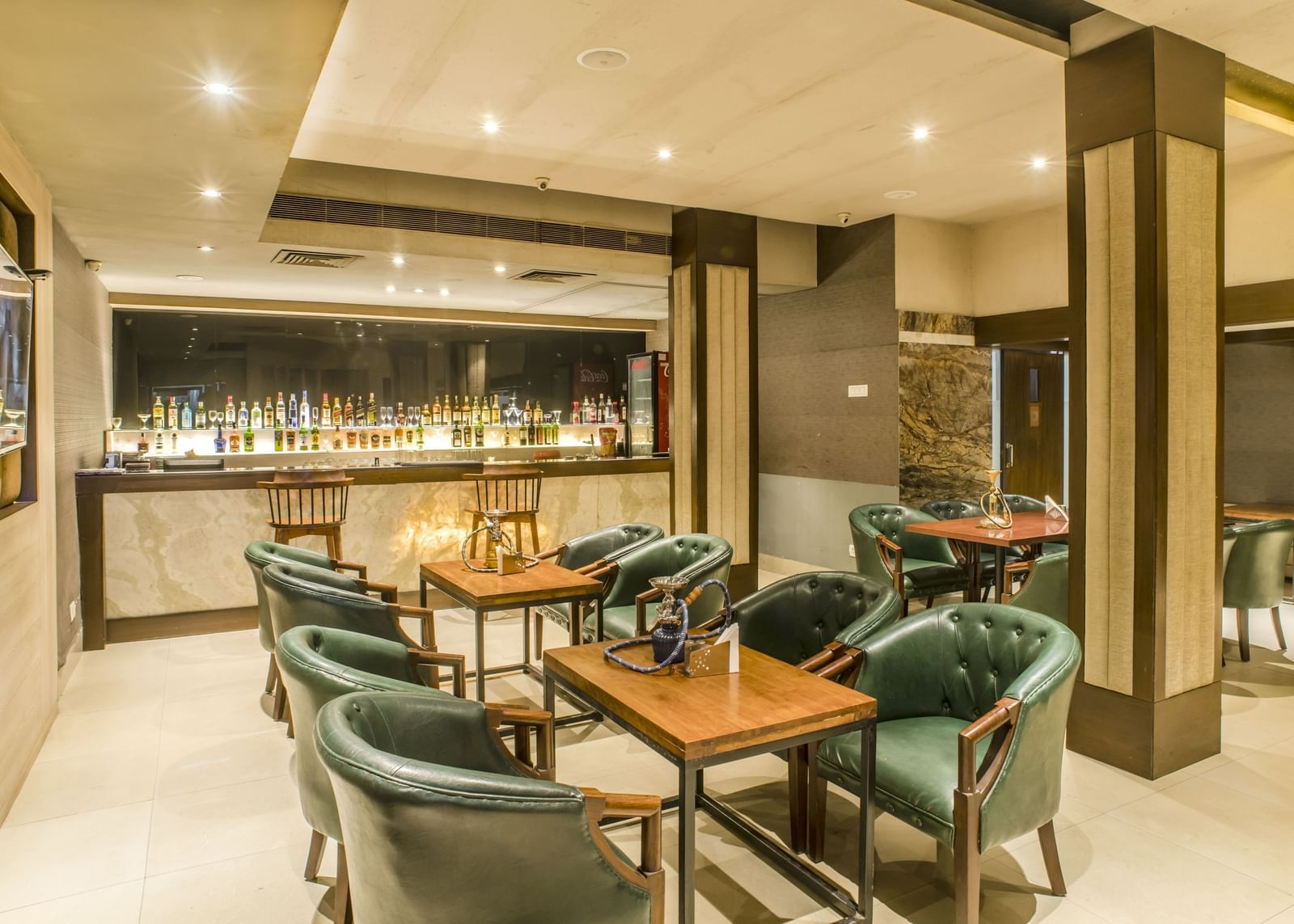 A bar area with tables and chairs at The Citi Residence Hotel, Asansol.