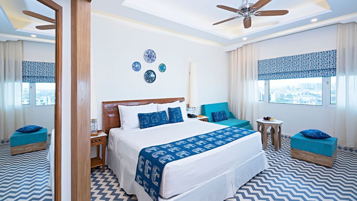 The panorama of our club rooms near Jaipur Airport featuring the furnitures, the mirror and the window.   23