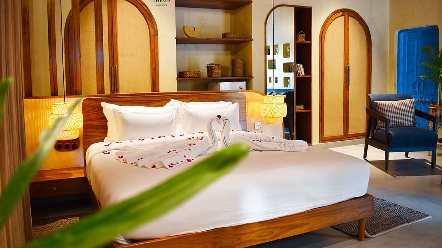 an image of a villa with a bed and a couch placed by its side at Themis Mudhouse - A Nature's Retreat Resort & Wellness