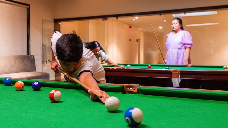 A man focusing on his next move in a game of snooker at Crescent Spa & Resort, Indore