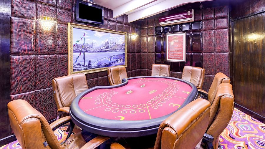 a casino board with chairs surrounding it - Mayfair Spa Resort & Casino Gangtok