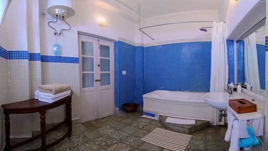Hill Fort Kesroli 14th Century Alwar - interior view of the Sitara Bathroom featuring a water heater, bathtub, a wash basin and a mirror