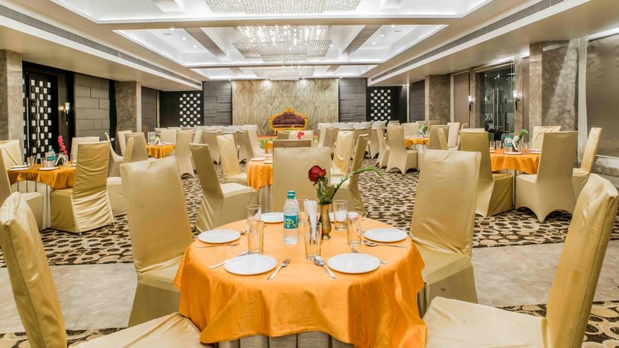 A banquet hall with round tables set for an event at The Citi Residenci Hotel, Durgapur.