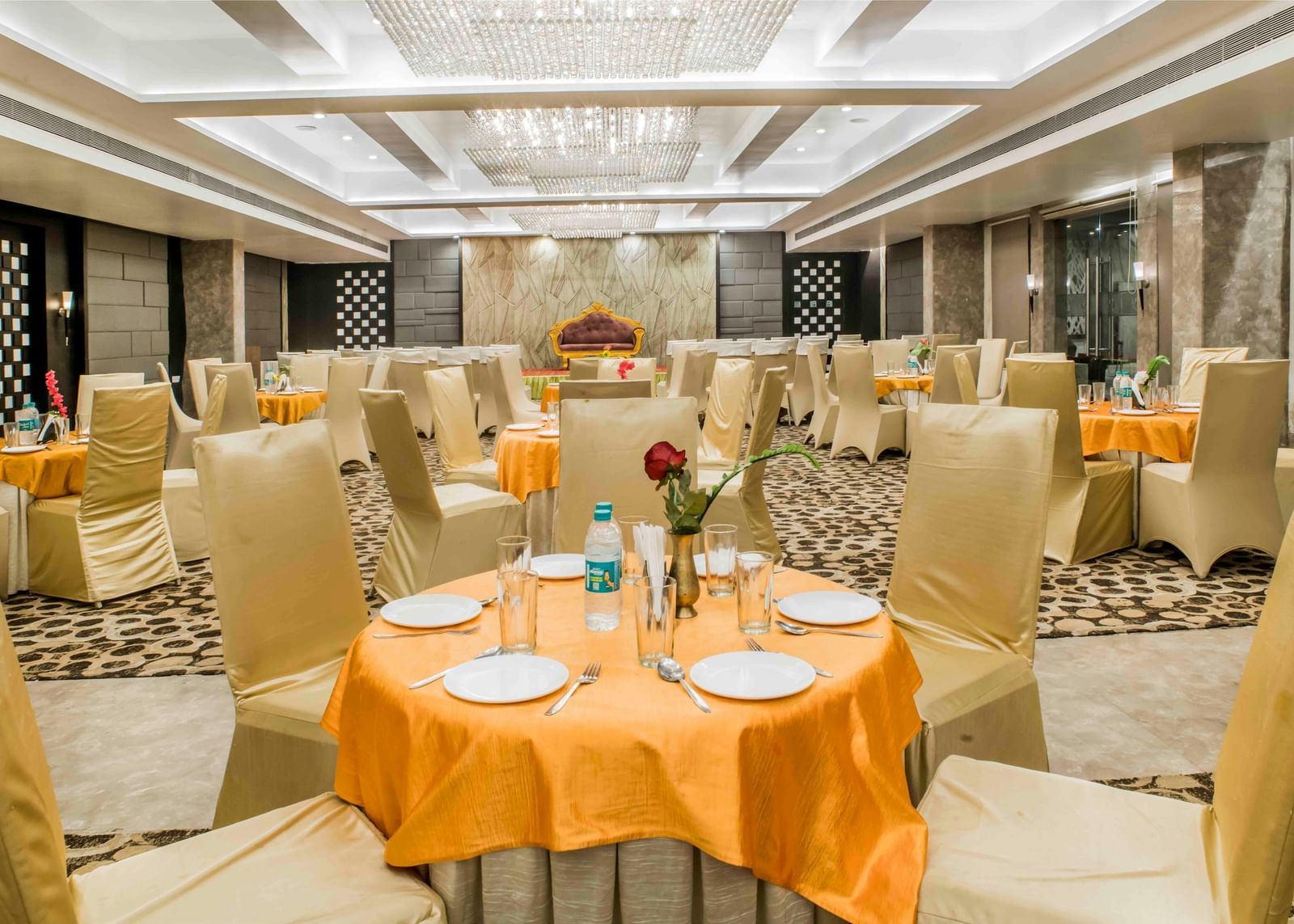A banquet hall with round tables set for an event at The Citi Residenci Hotel, Durgapur.