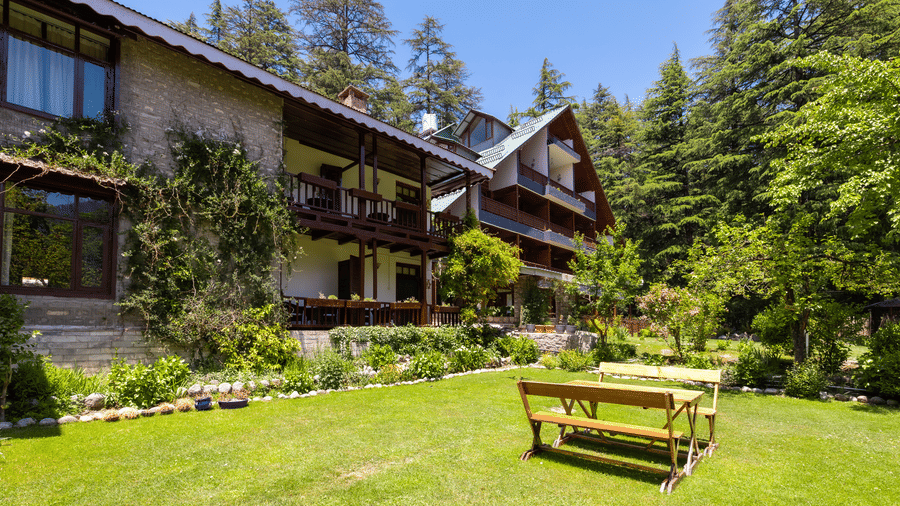 A view of the lawn in a property with seating arrangements at Bedzzz Xclusiv Baikunth, Manali