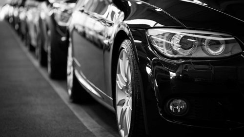 close up image of a car parked with several other in line