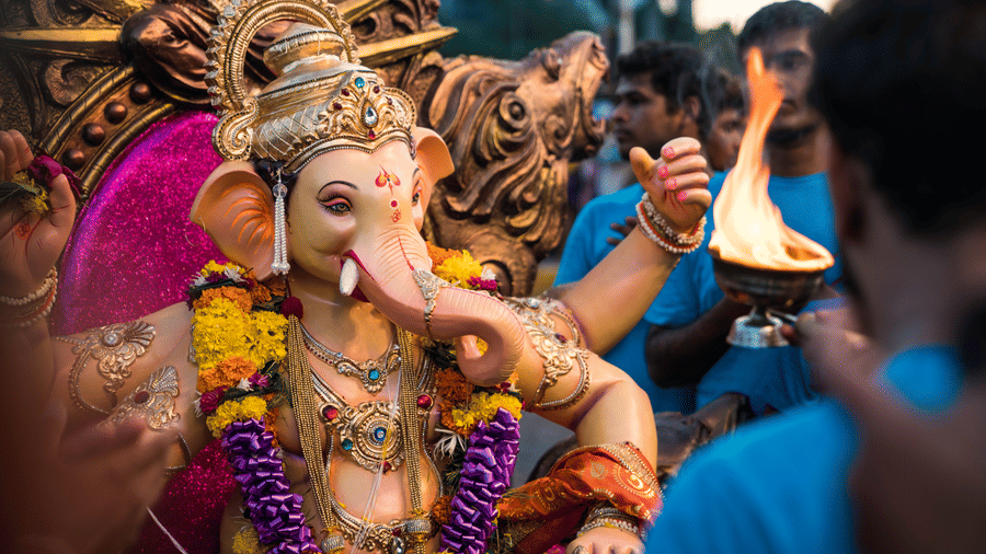 ganesh chaturthi in Goa during monsoon with people taking aarti 