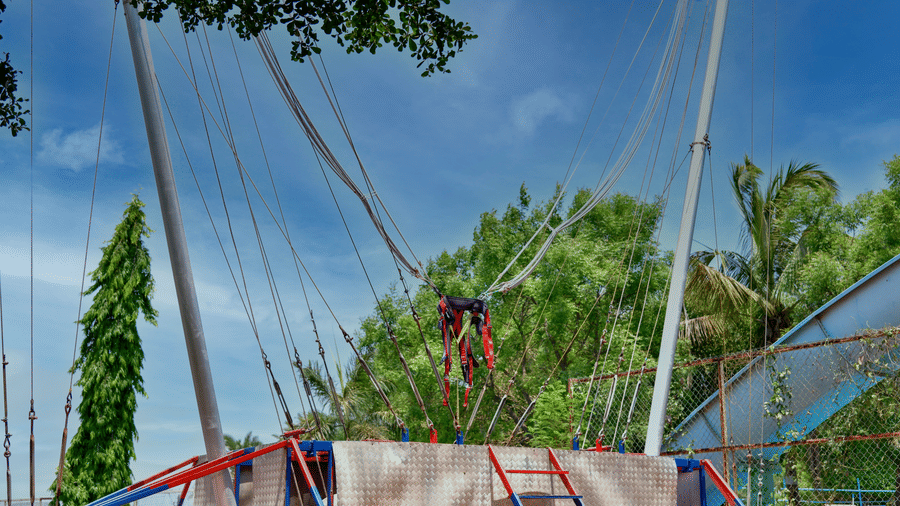 Outdoor zip line setup with multiple cables and harnesses in a park setting at Diamond Parks, Pune - one of the best Instagrammable places in Pune.