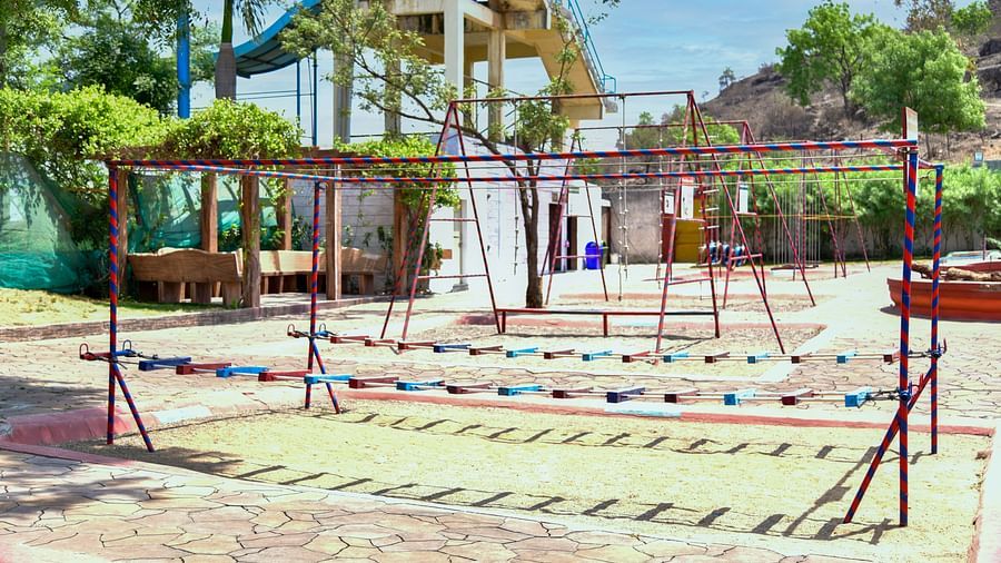 Outdoor playground with swings and climbing equipment in a tropical setting |  Diamond Parks, Pune 