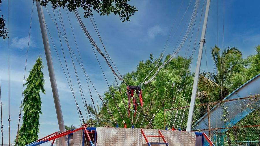 Outdoor zip line setup with multiple cables and harnesses in a park setting |  Diamond Parks, Pune 