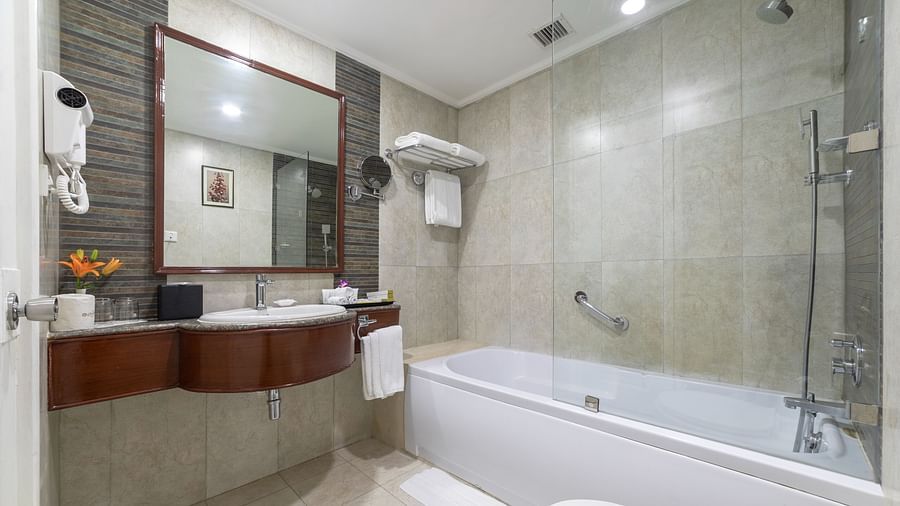 Bathroom of Shiraz Premium Room with a bathtub alongside a vanity area