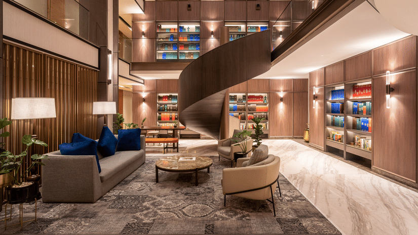 A lounge area at The Residency Towers Chennai with a unique bar counter, seating, and decorative elements.