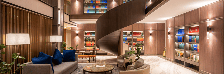 A lounge area at The Residency Towers Chennai with a unique bar counter, seating, and decorative elements.