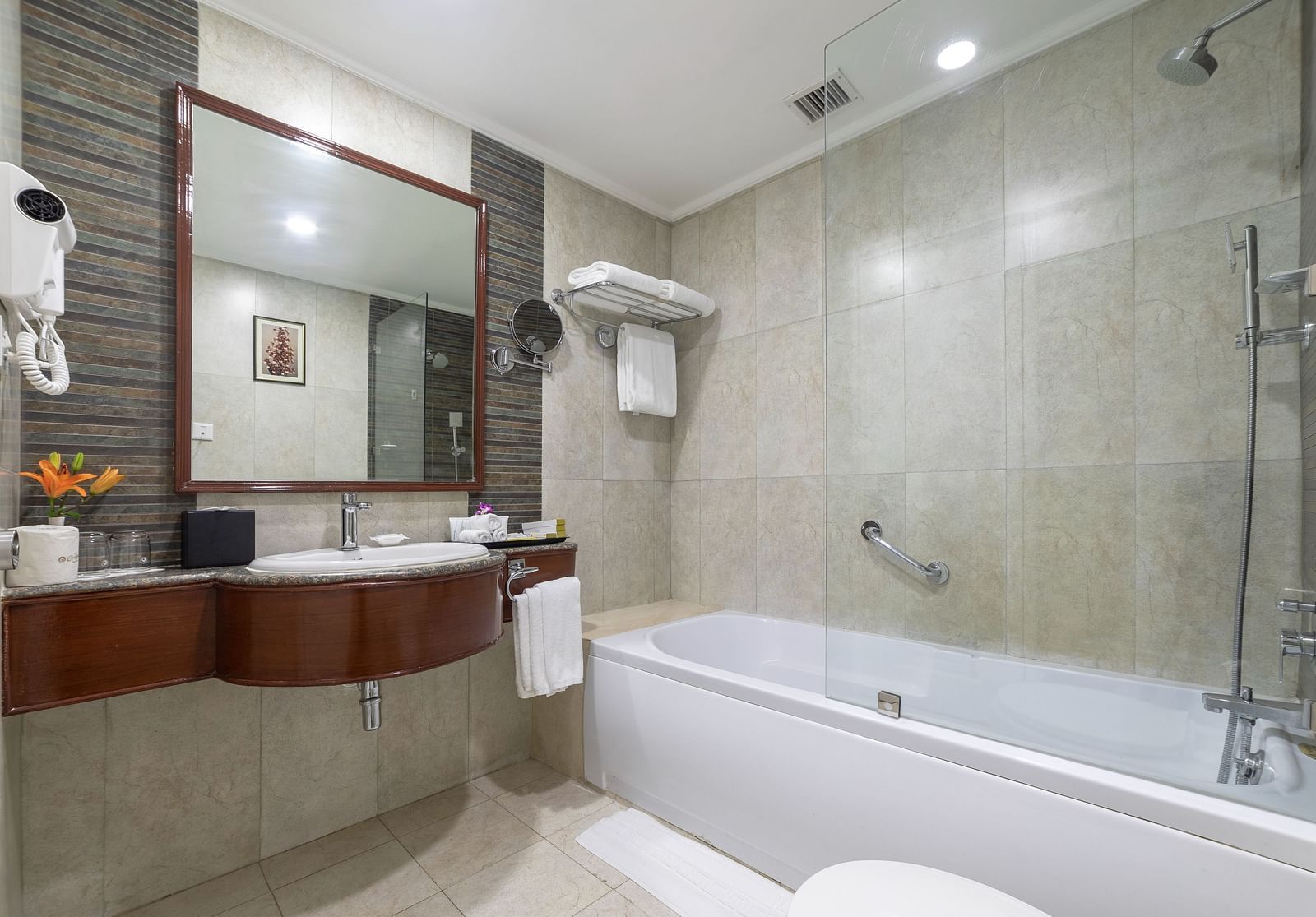 Bathroom of Shiraz Premium Room with a bathtub alongside a vanity area