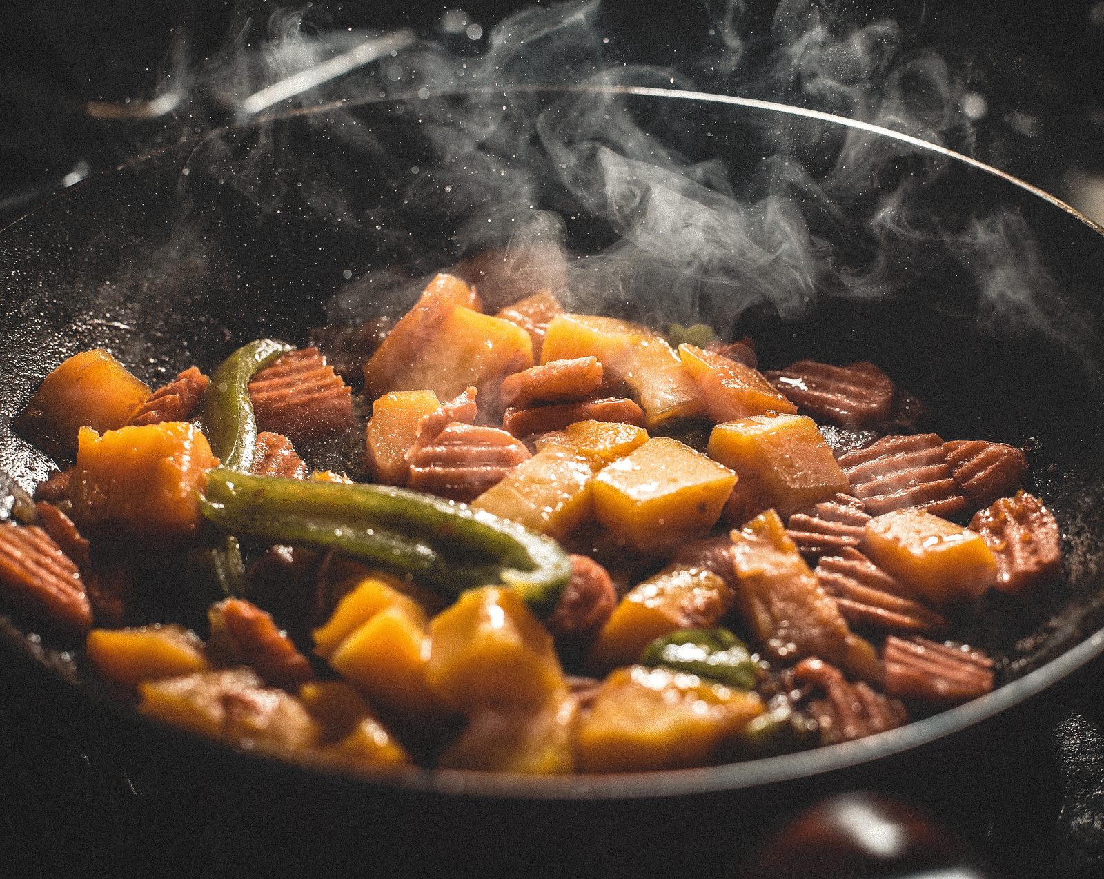 An close -up image of  delicious-looking dish being cooked in a pan.