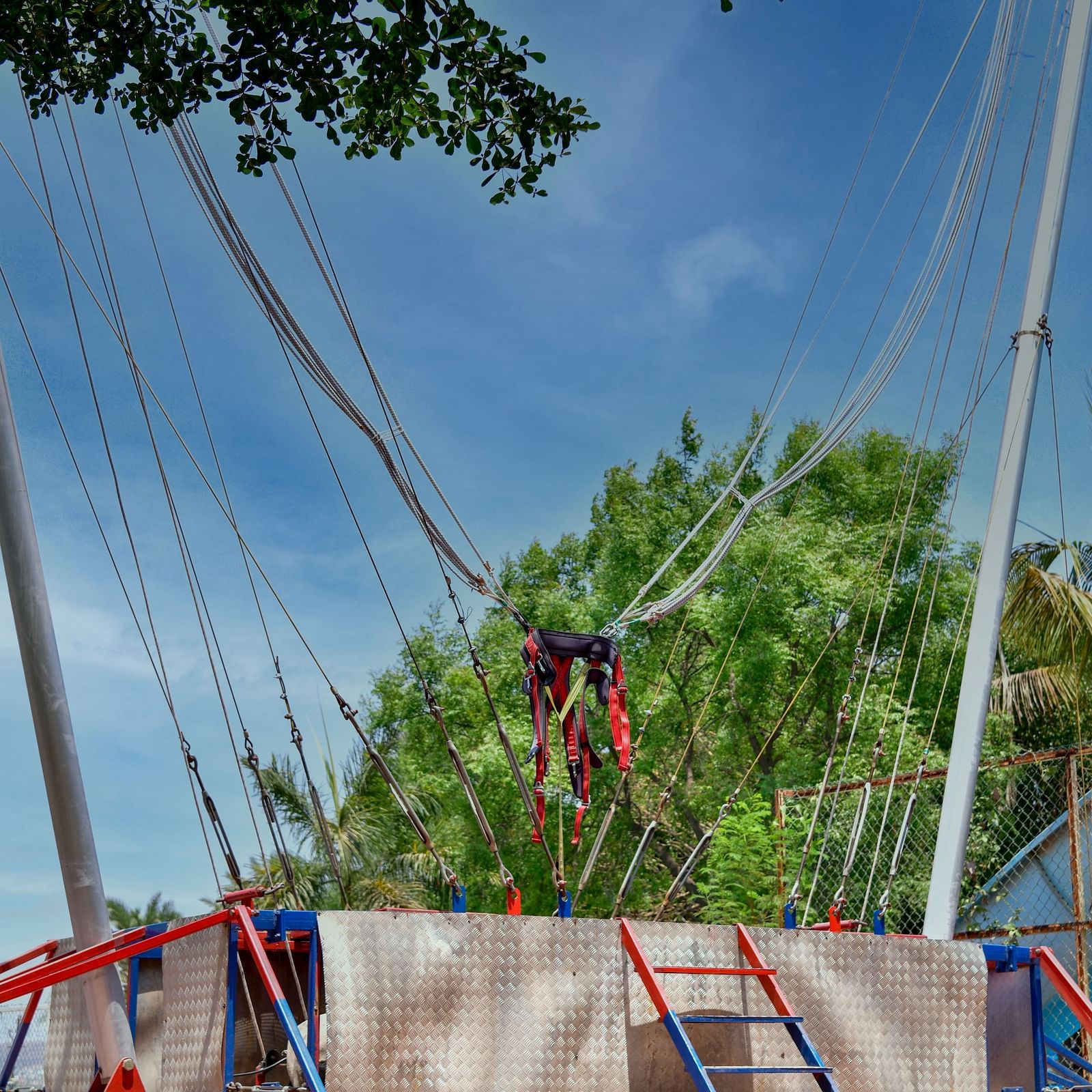 Outdoor zip line setup with multiple cables and harnesses in a park setting |  Diamond Parks, Pune 