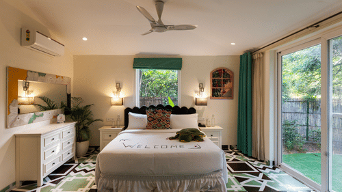 A double bed with a dresser on the side inside Garden Suite - Karma Lakelands.