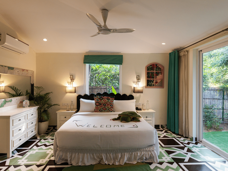 A double bed with a dresser on the side inside Garden Suite - Karma Lakelands.