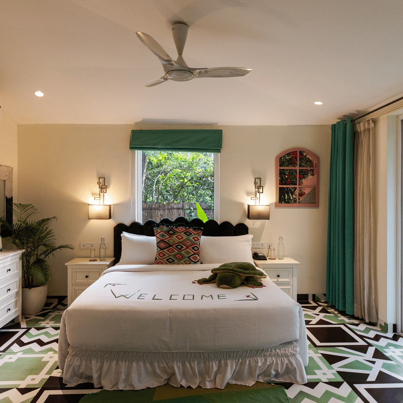 A double bed with a dresser on the side inside Garden Suite - Karma Lakelands.