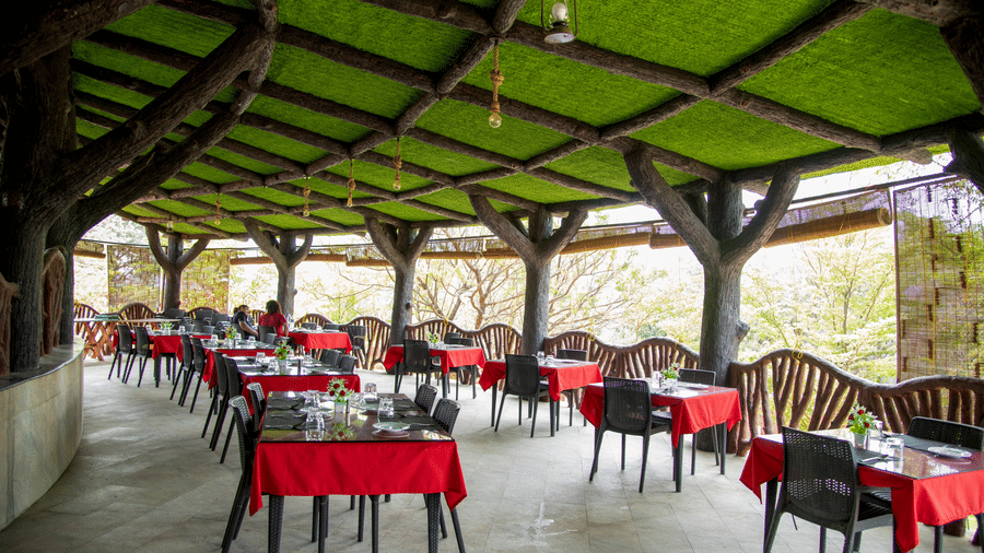 A cafeteria with two seater and four seater dining tables at Diamond Parks, Pune.