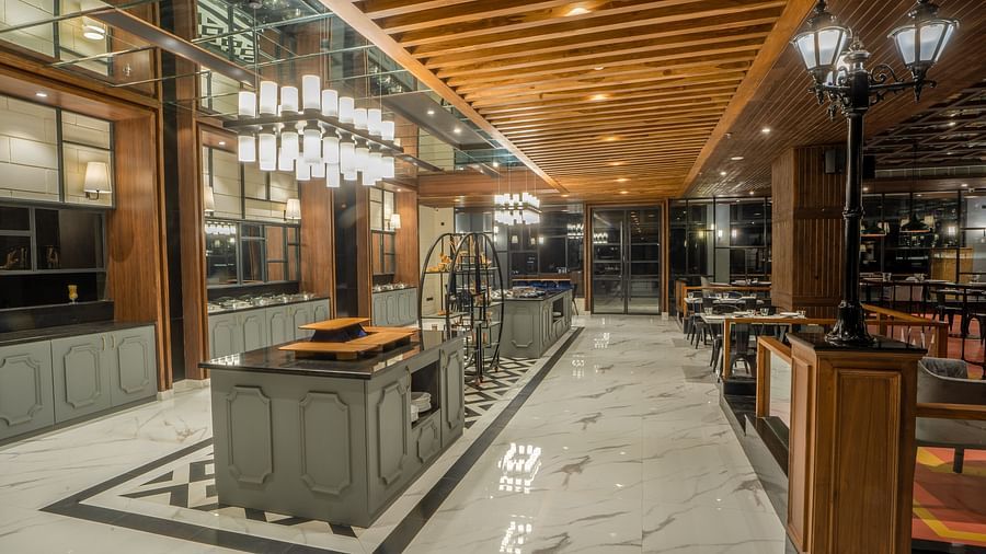 An image of a kitchen that has a long counter top meant for cooking and placing things -  Hotel Polo Towers, Agartala