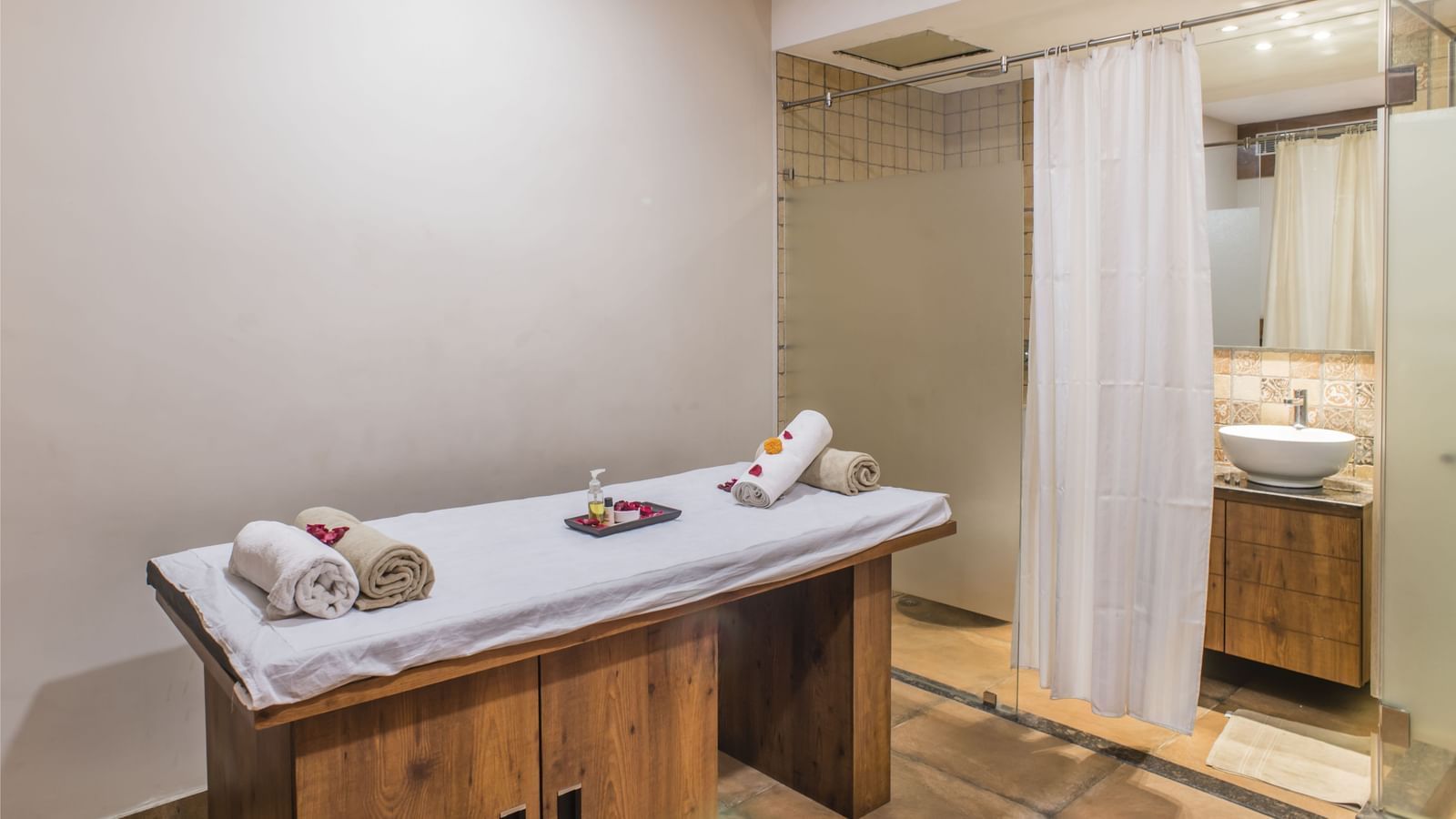 A spa treatment room with a massage table at The Citi Residenci Hotel, Asansol.