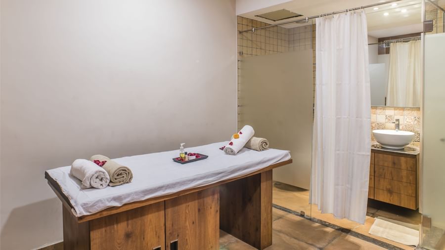 A spa treatment room with a massage table at The Citi Residenci Hotel, Asansol.