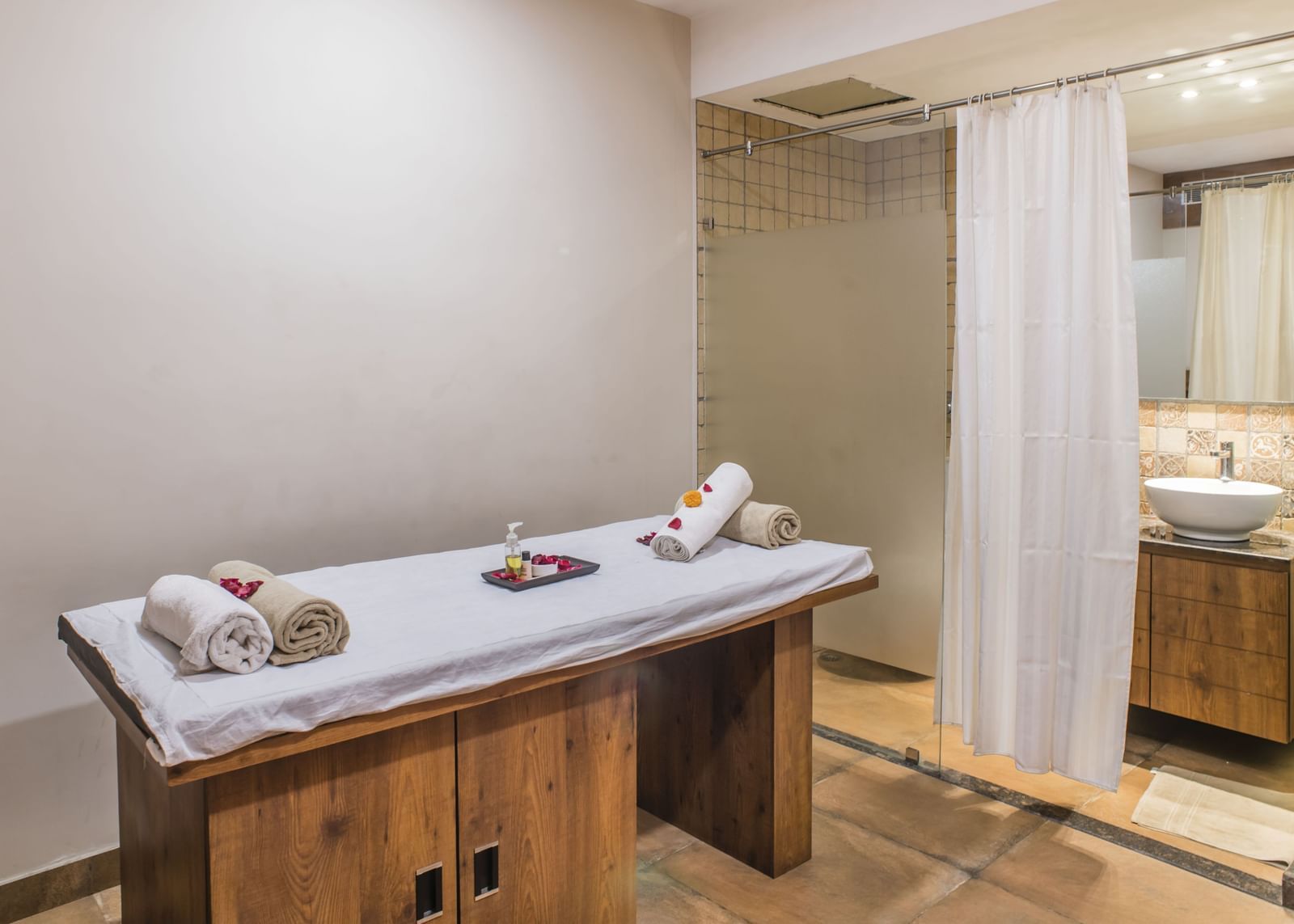 A spa treatment room with a massage table at The Citi Residenci Hotel, Asansol.