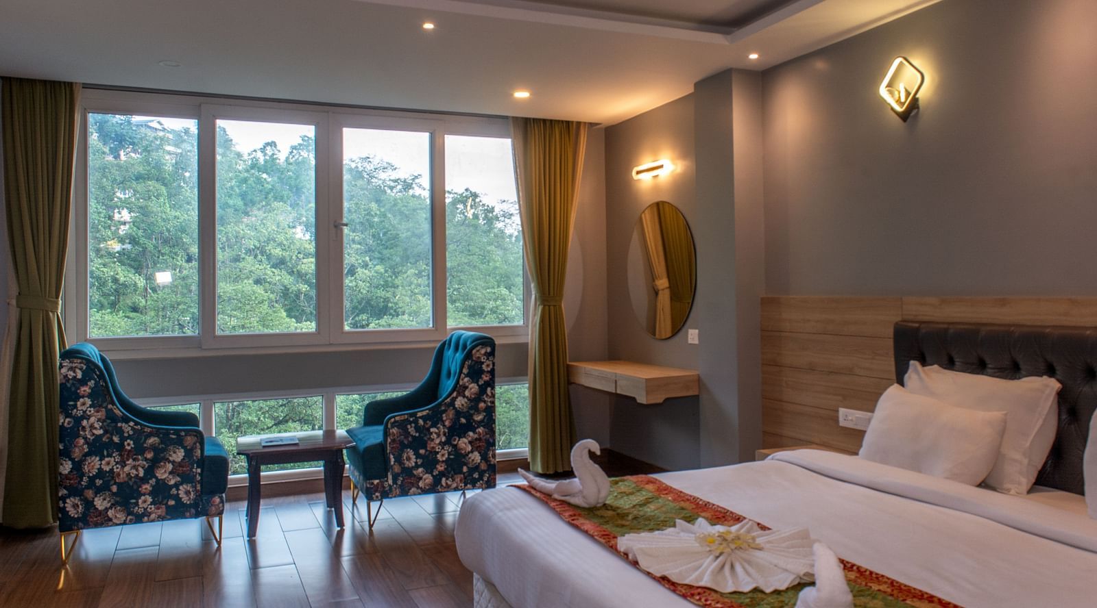 Premuim river view room with bed, seating area and large windows at  Avianna Ganagtok Resort and Spa