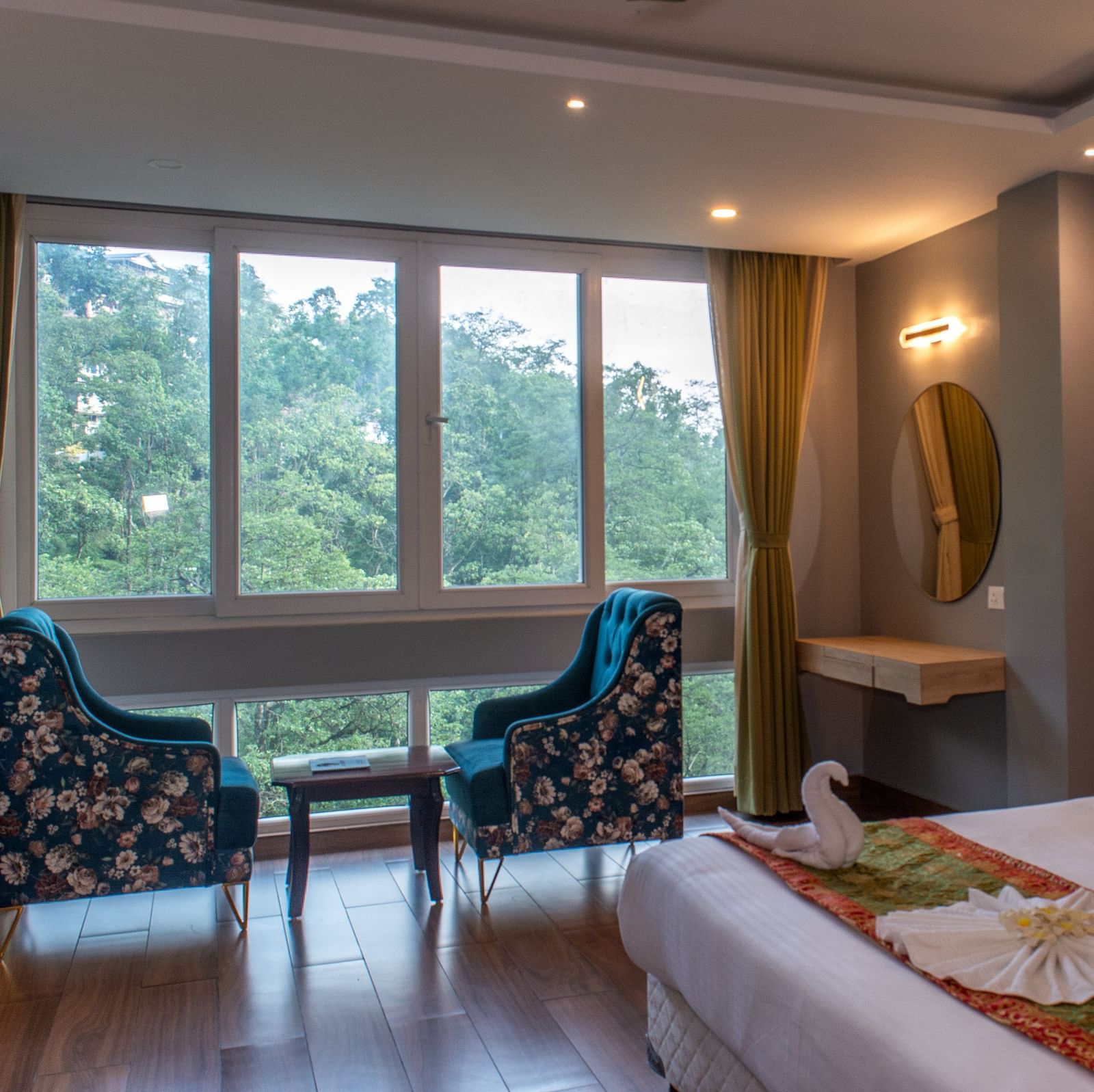 Premuim river view room with bed, seating area and large windows at  Avianna Ganagtok Resort and Spa