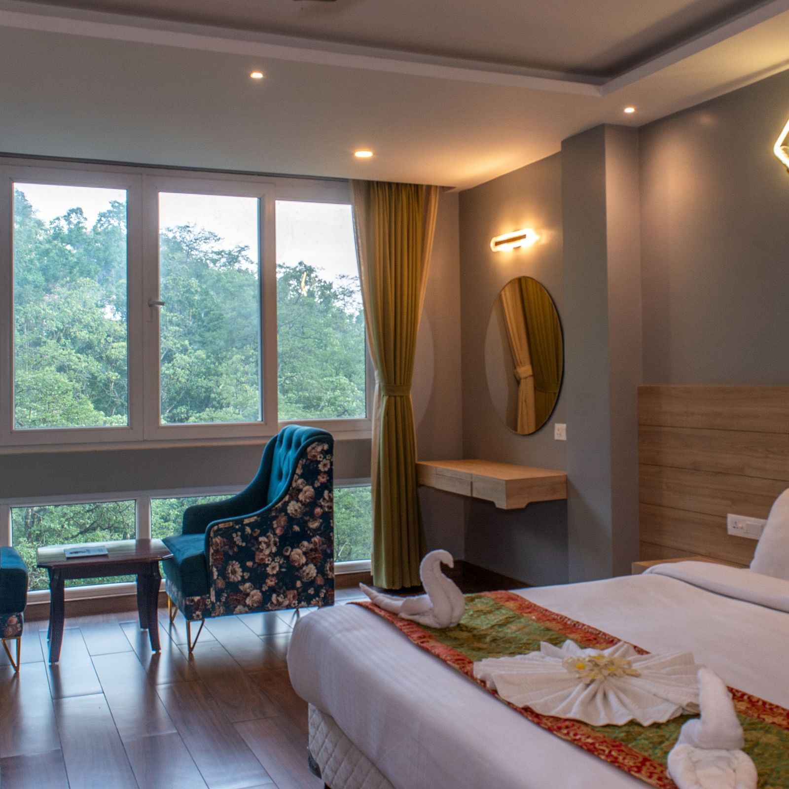 Premuim river view room with bed, seating area and large windows at  Avianna Ganagtok Resort and Spa