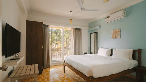 Chic bedroom with a TV and serene ambiance at One BHK Apartment, Richmonde Ananta Elite, Goa.