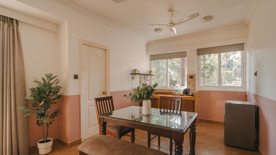 Cosy dining and living area with natural lighting at One BHK Apartment, Richmonde Ananta Elite, Goa.