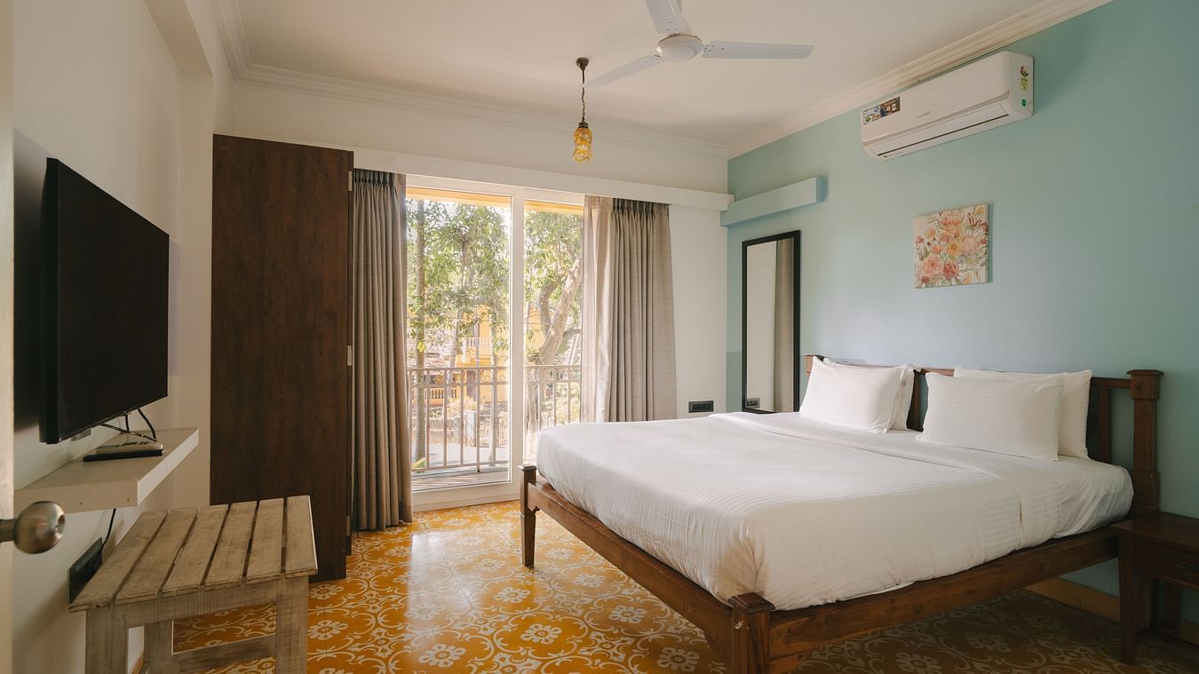 Chic bedroom with a TV and serene ambiance at One BHK Apartment, Richmonde Ananta Elite, Goa.