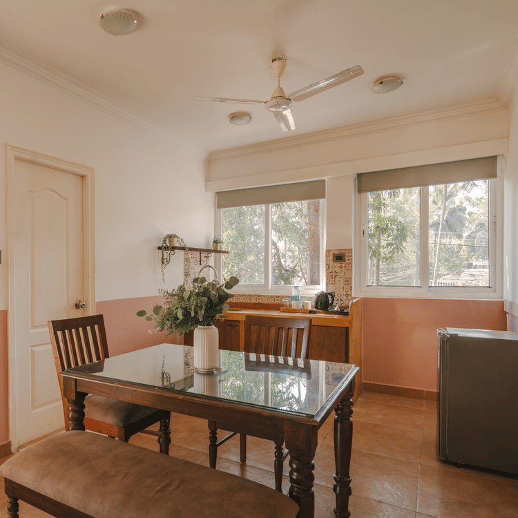 Cosy dining and living area with natural lighting at One BHK Apartment, Richmonde Ananta Elite, Goa.