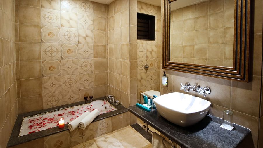 Bathtub and sink inside the bathroom of Regalia Bathtub Room at Rahi Forest View