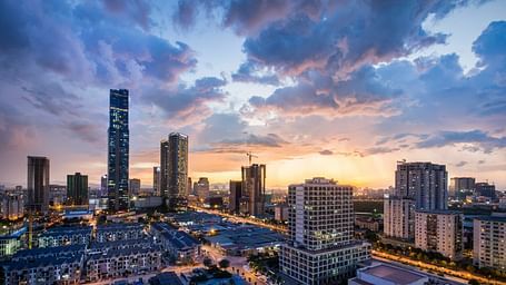 A far-out view of the city of Hanoi with sky scrapers and dark clouds in view