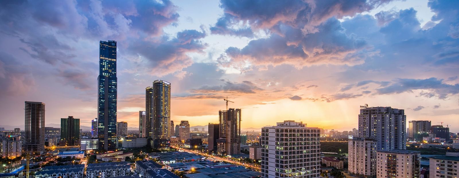 A far-out view of the city of Hanoi with sky scrapers and dark clouds in view