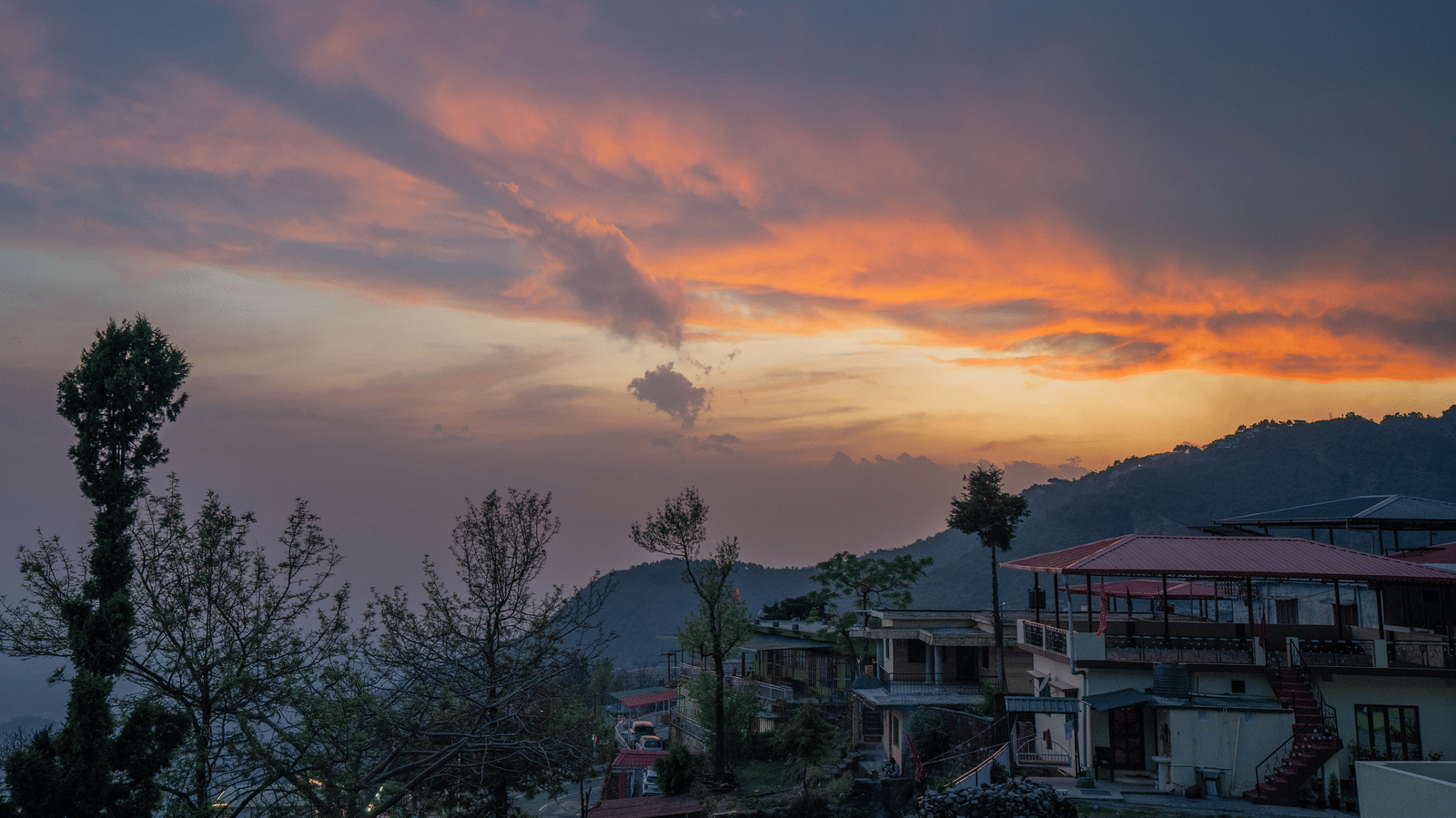 A sunset view over the hills and town from Perfectstayz Value Paradise, Mussoorie.