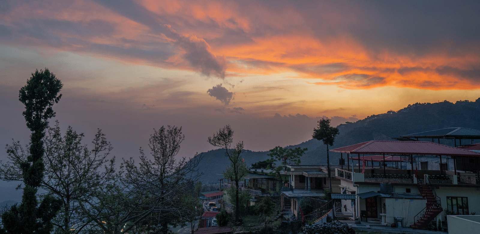 A sunset view over the hills and town from Perfectstayz Value Paradise, Mussoorie.