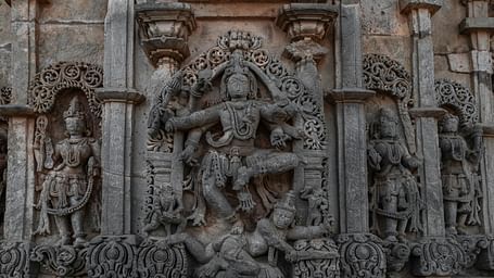 Close-up of an intricately carved stone temple wall with detailed sculptures.