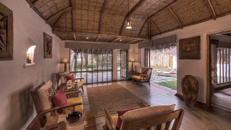 Bright jungle villa living area with forest views at Evolve Back Kabini